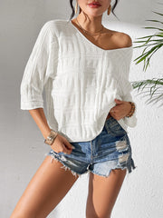 White textured knit dolman sleeve sweater with a v-neckline and 3/4 sleeves.