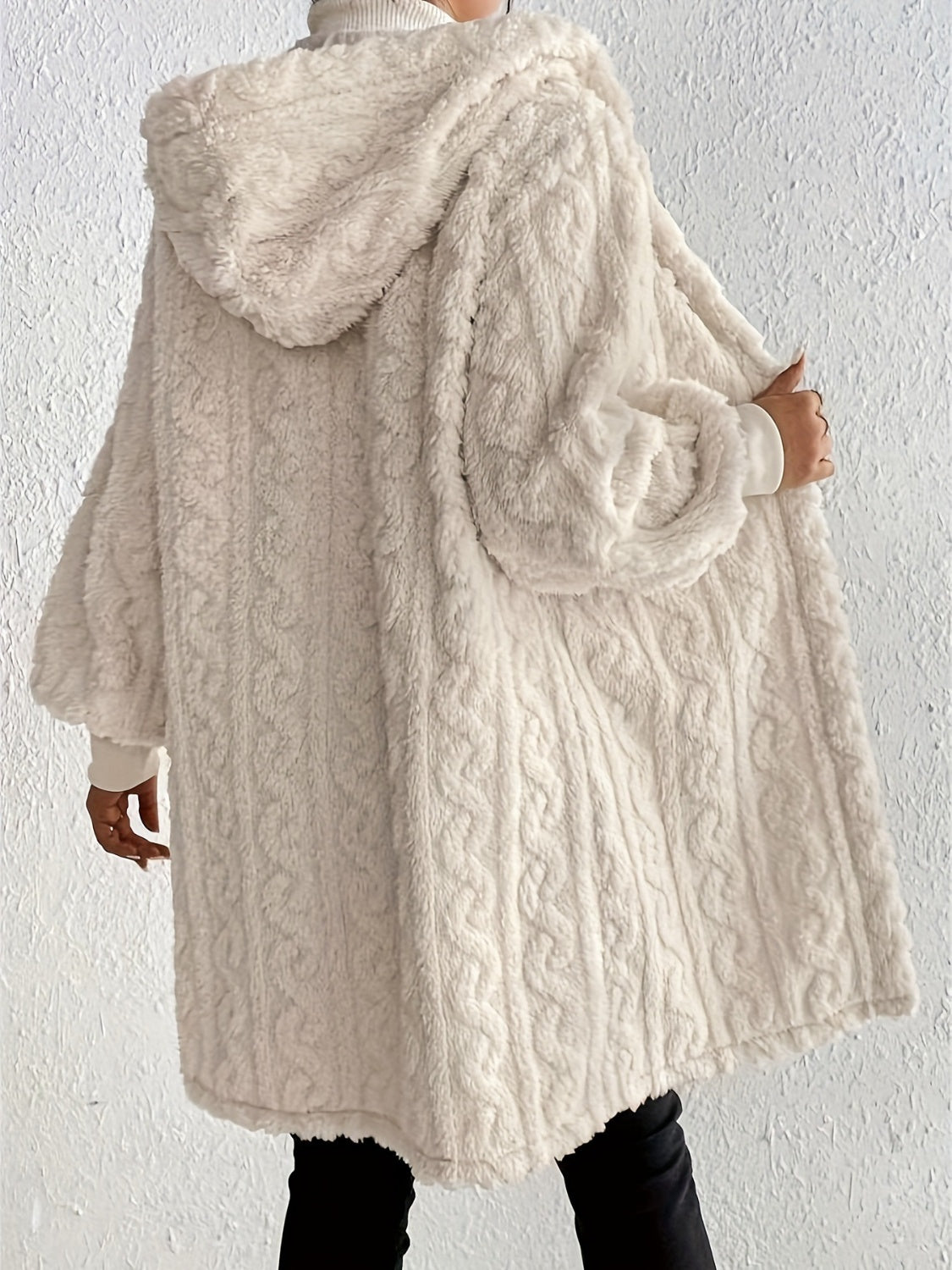 Beige hooded cocoon coat with textured cable knit and plush finish.