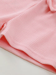 Pink waffle knit tank and bow shorts set detail.
