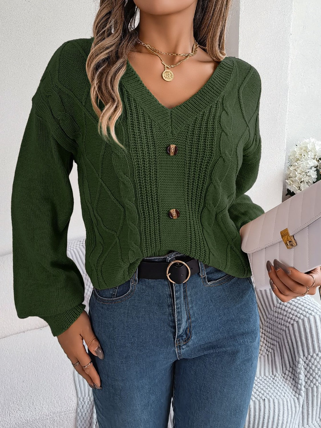 Army green cable knit button-front cardigan with V-neck and balloon sleeves.