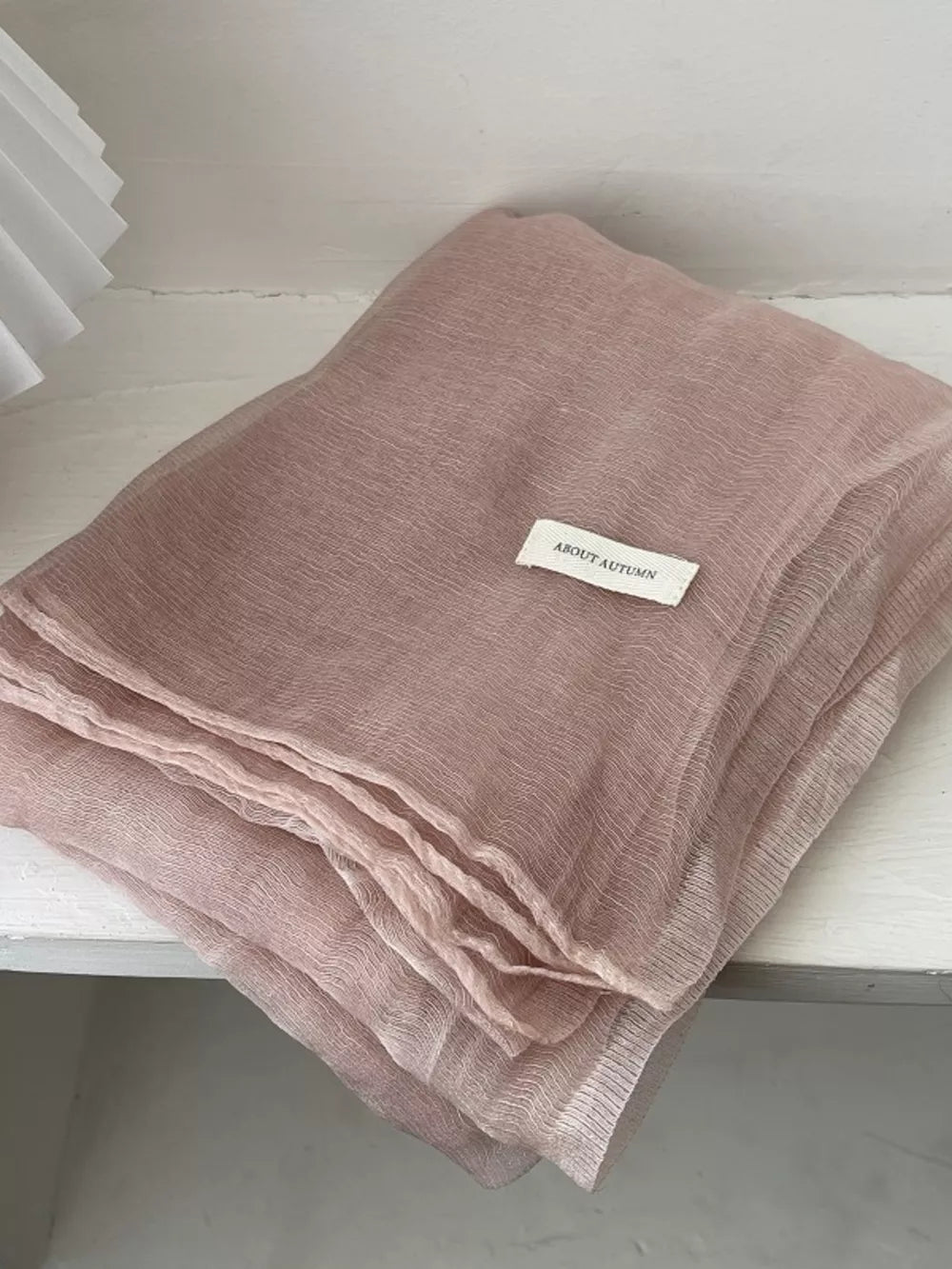Delicate sheer polyester scarf in Quicksand Powder with a subtle crinkle texture.