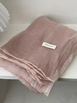 Delicate sheer polyester scarf in Quicksand Powder with a subtle crinkle texture.