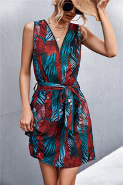 Floral zip-front mini dress with tie waist in red and teal palm print