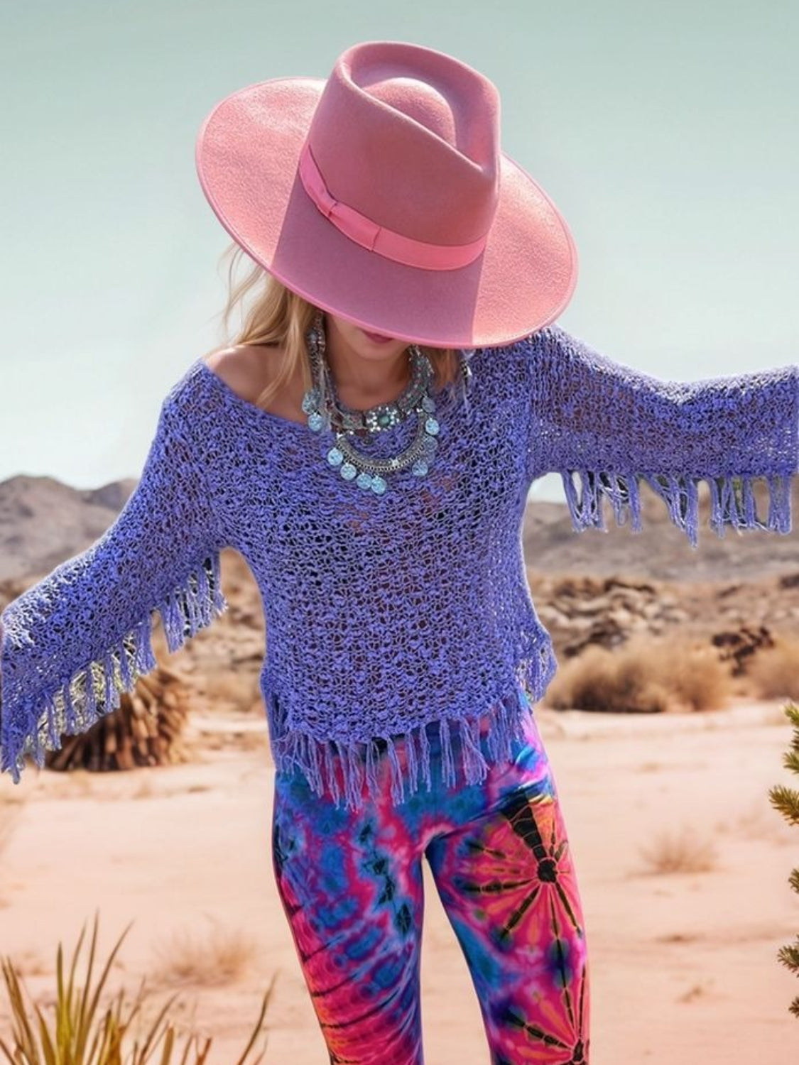 Open-knit boatneck sweater in electric purple with fringe details and bell sleeves.