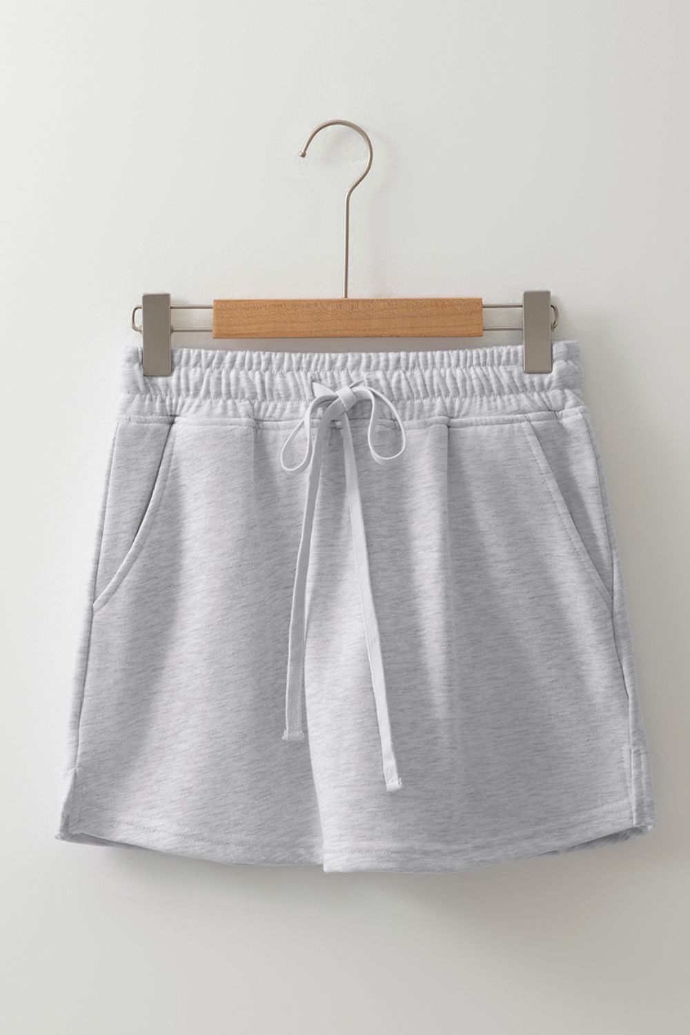 Light gray French terry skort with drawstring, pockets, and elastic waistband.