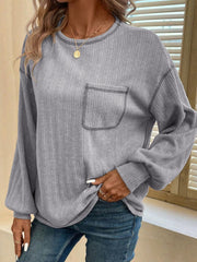 Gray ribbed knit long sleeve top with contrast stitching detail and chest pocket.