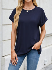 Basic navy crew neck t-shirt with cuffed short sleeves, styled with jeans.