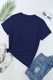 Dark blue crewneck tee with cuffed sleeves and a knotted hem, styled with denim shorts.