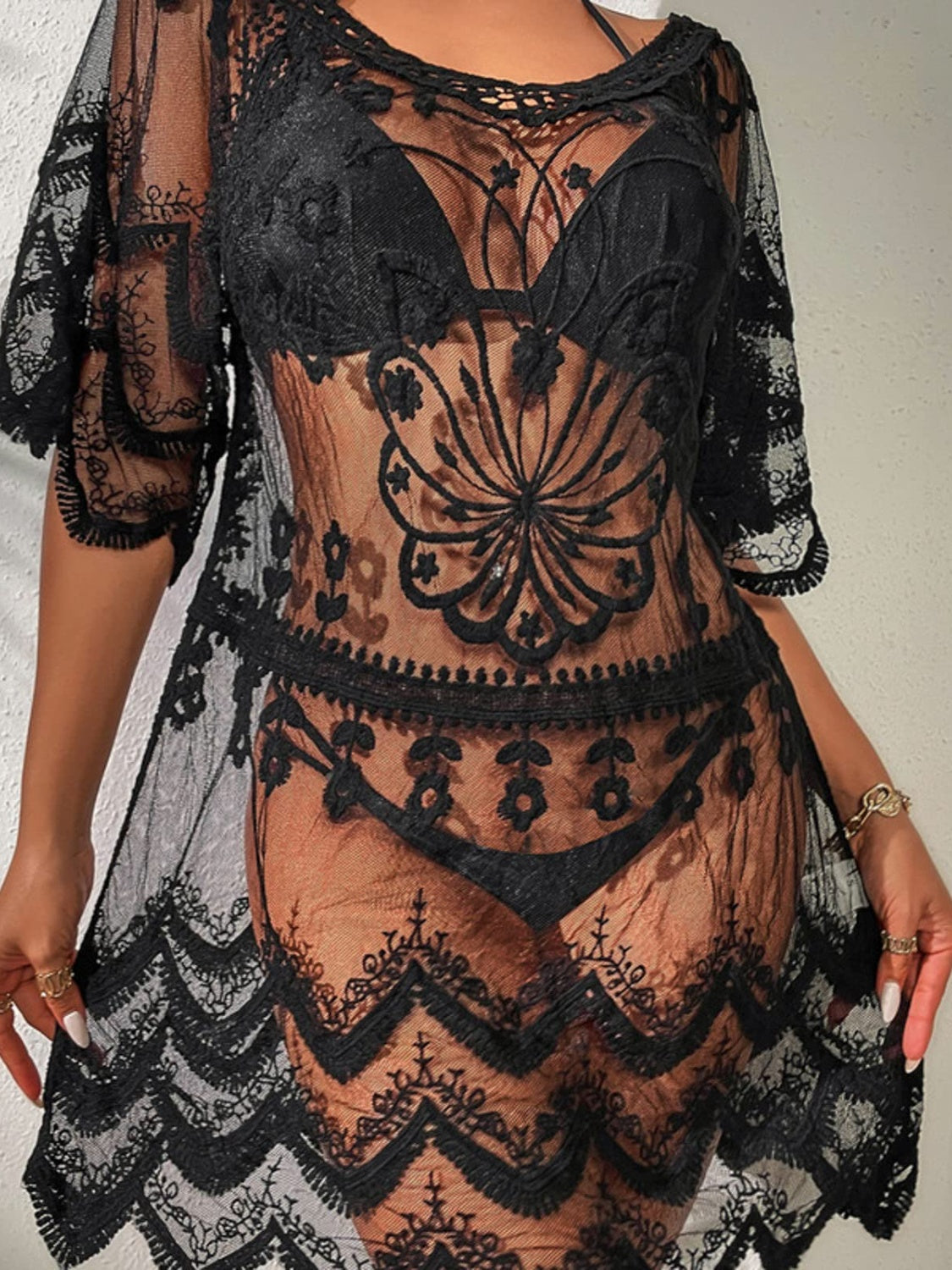 Black lace kaftan cover-up with intricate floral embroidery and scalloped hem.