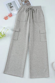 Gray wide-leg cargo lounge trousers with utility pockets and drawstring waist