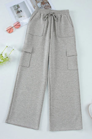 Gray wide-leg cargo lounge trousers with utility pockets and drawstring waist