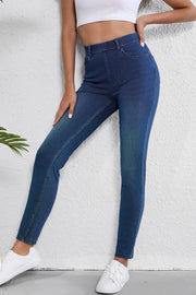 Medium wash denim high-waisted pull-on jeans with a slim fit and ankle length.