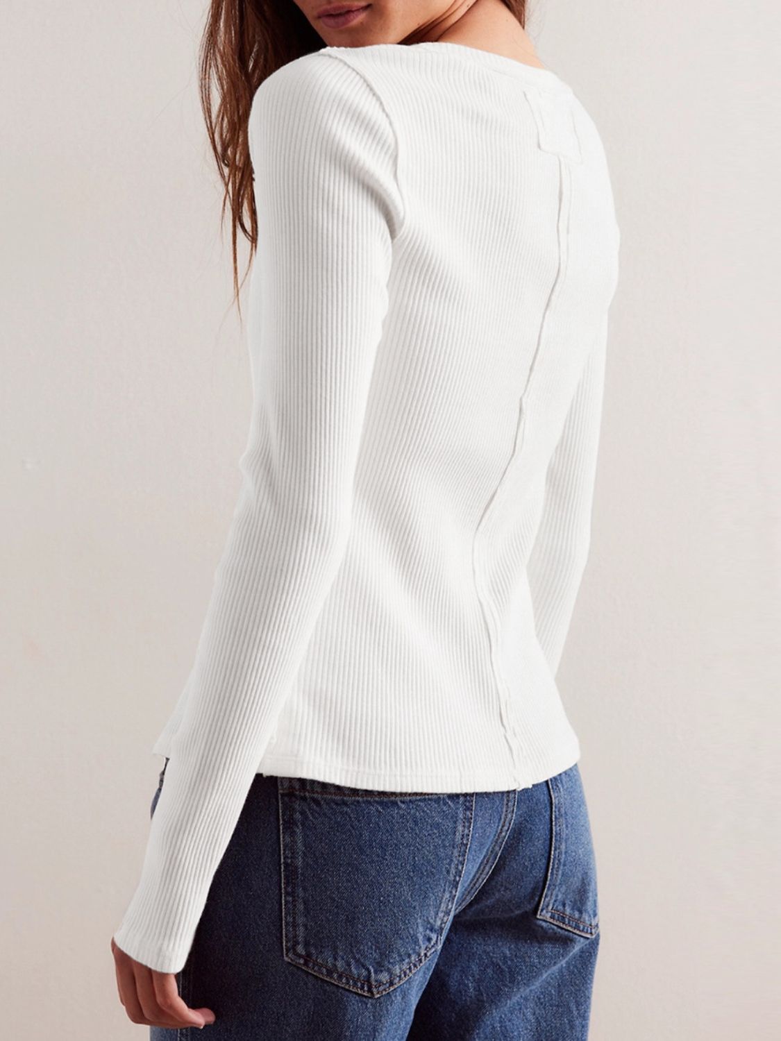 Ivory ribbed button-up second-skin top with long sleeves and a seam detail down the back.