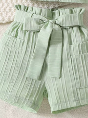 Light Green ribbed toddler shorts with ruffled waist and bow tie detail.