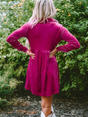 Deep Rose velvet babydoll button-down mini dress with a gathered waist and long sleeves.