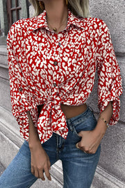 Women's red abstract spot print oversized shirt with button front and tie waist.