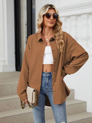 Oversized corduroy shirt jacket in brown with button front and collar.