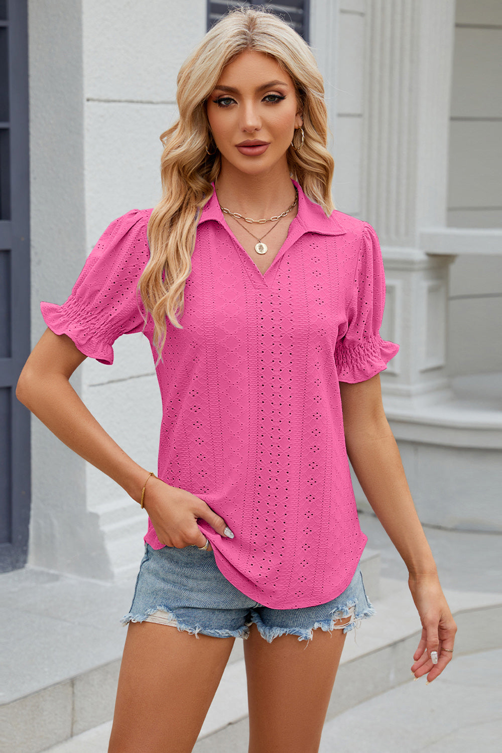 Hot Pink eyelet polo blouse with short puff sleeves and ruffled cuffs.