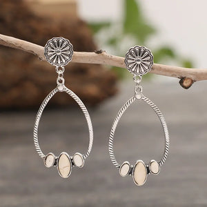 Southwestern teardrop earrings with ivory stones and silver alloy in a boho style.