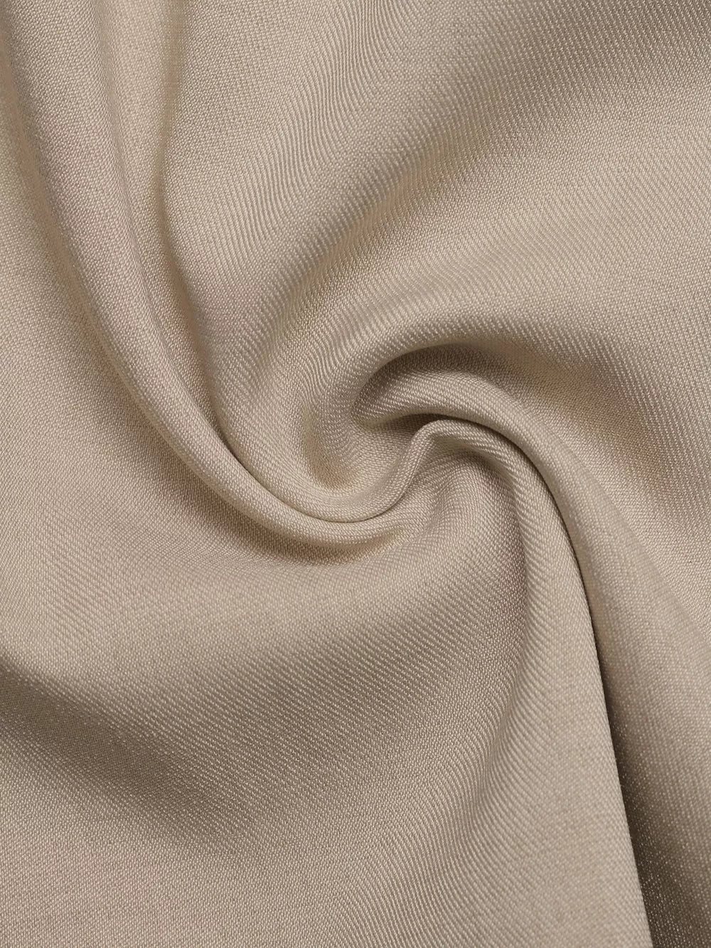 Close-up of beige fabric texture with subtle ribbing.