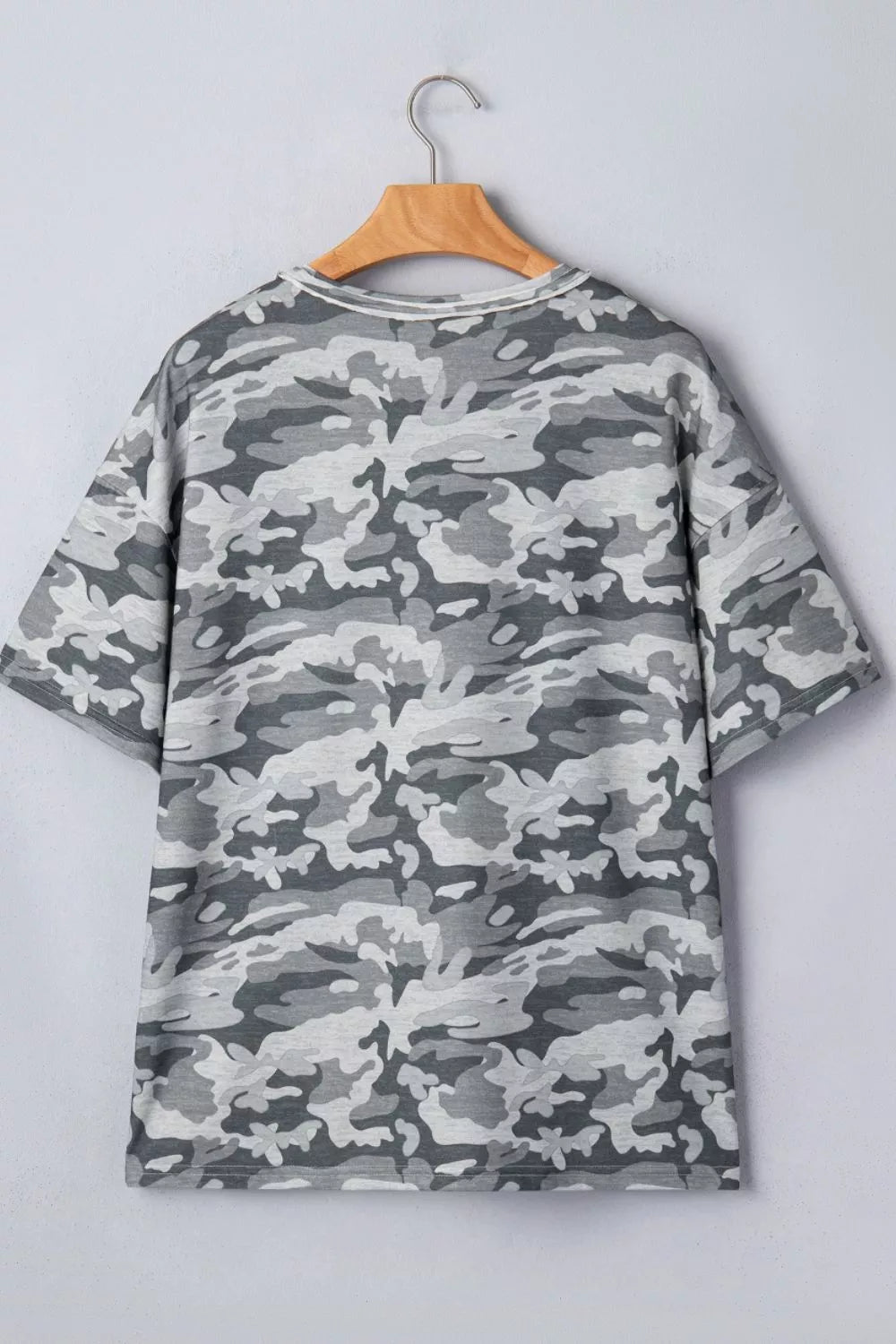 Camouflage v-neck relaxed tee with short sleeves and a grey camo pattern.