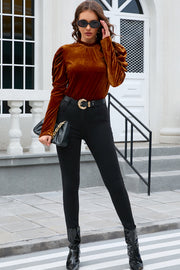 Brown velvet blouse with gathered puff sleeves and mock neck.