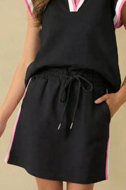 Black blouse and shorts set with contrast trim and drawstring waist.