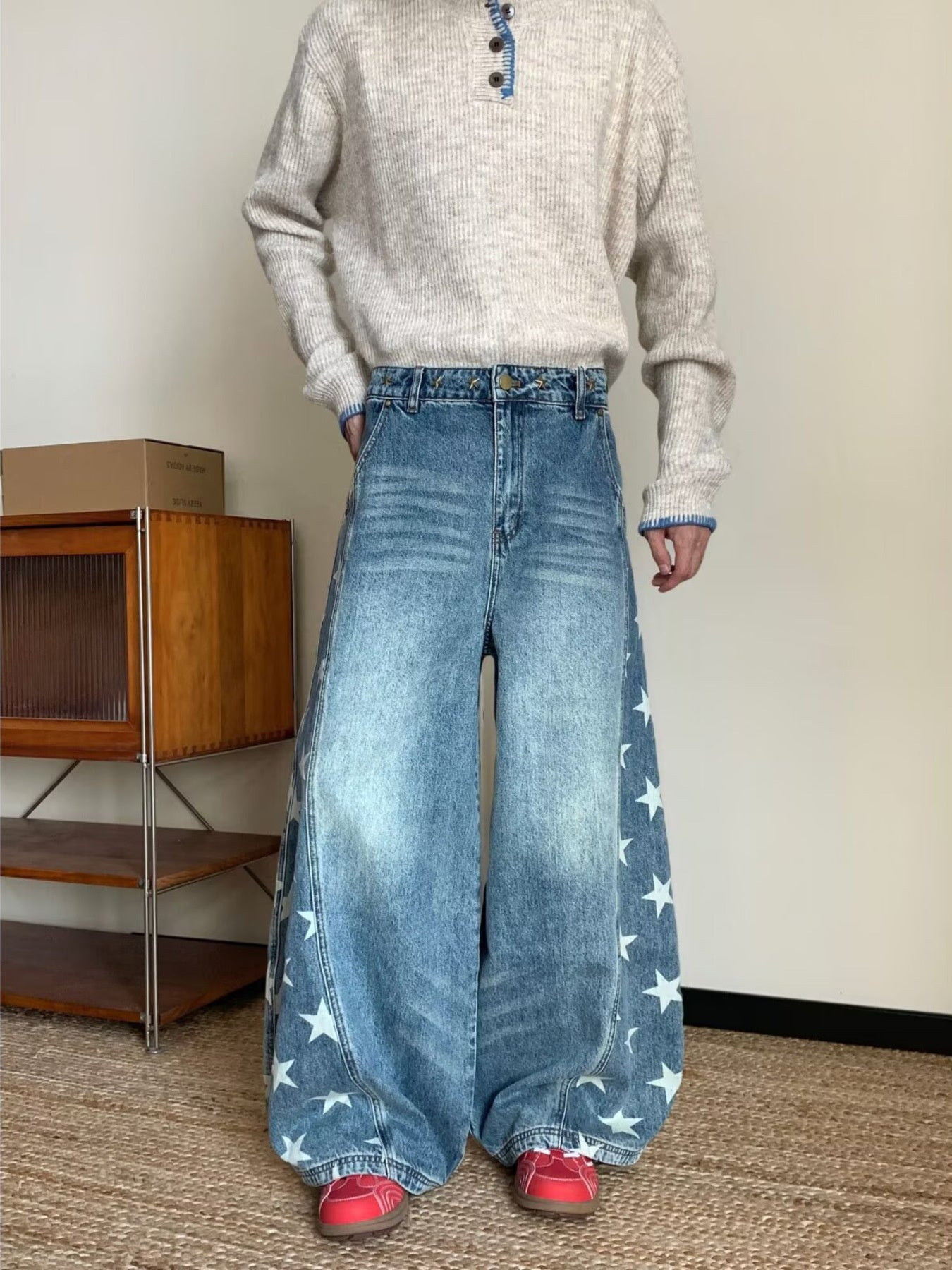 Men's blue wide leg jeans with star print and distressed wash.