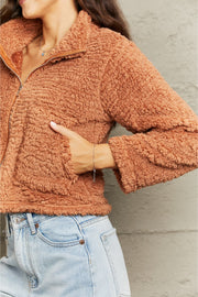 Caramel teddy fleece cropped jacket with a collared neckline and zipper closure.