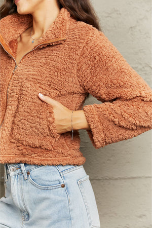 Caramel teddy fleece cropped jacket with a collared neckline and zipper closure.