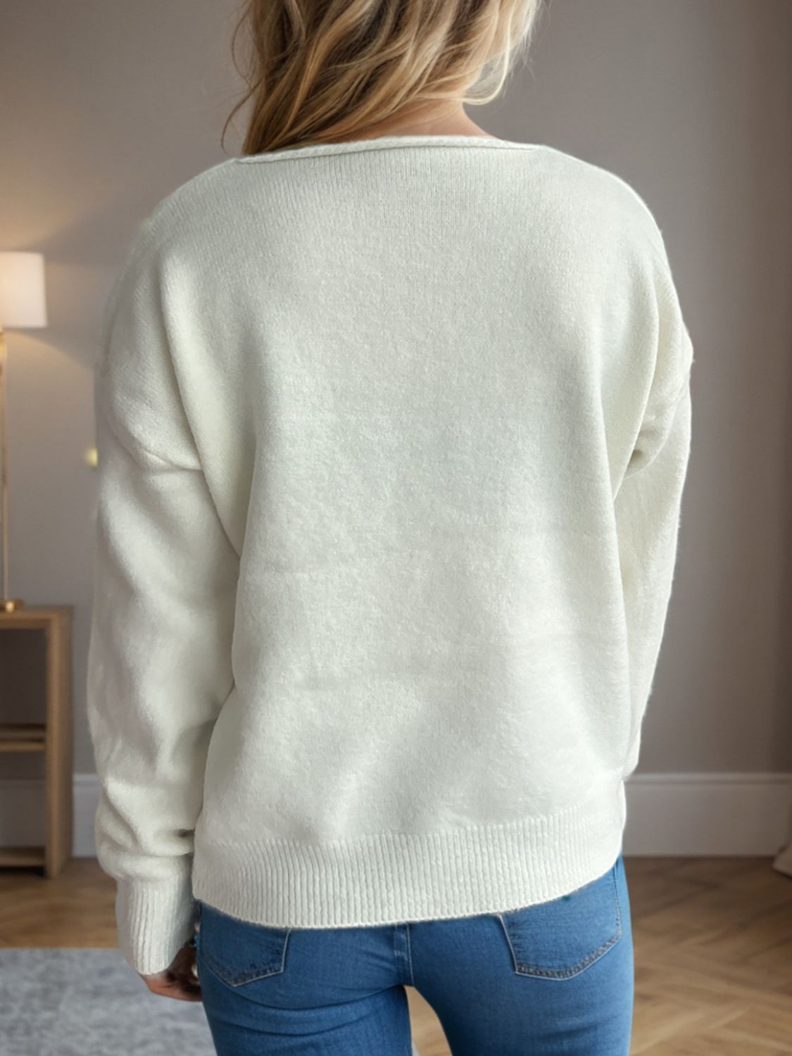 Relaxed-fit white acrylic V-neck sweater with ribbed hem and cuffs.