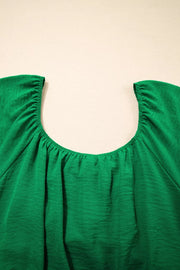 Green ruched maternity peplum shirt with a gathered neckline and textured polyester fabric.