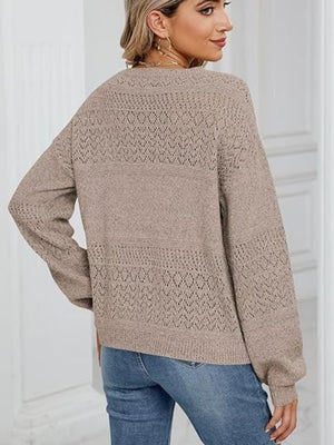 Eyelet stitch V-neck pullover sweater in tan with long sleeves and a relaxed fit.