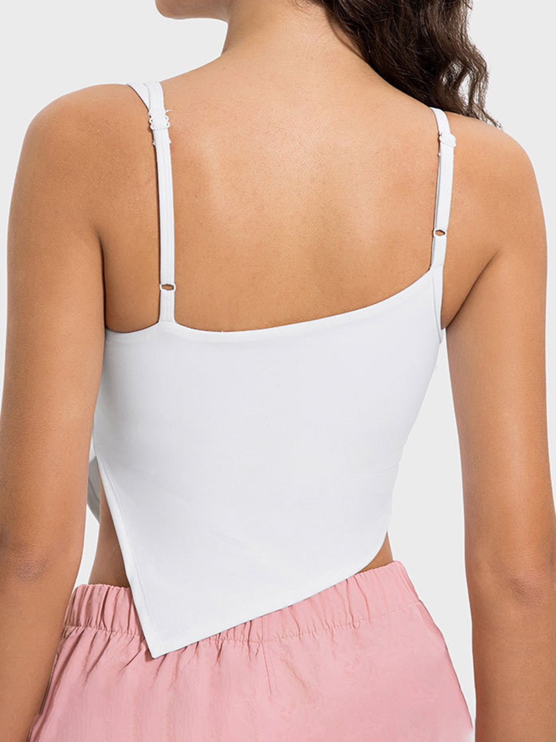 White asymmetric cutout cami tank top with adjustable straps and a unique hem