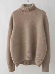 Beige acrylic knit turtleneck sweater with dropped shoulders and ribbed cuffs and hem.
