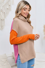 Colorblock knit turtleneck sweater in tan with orange and pink sleeves and side panels.