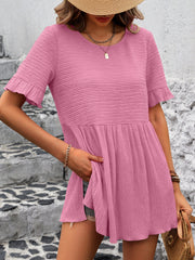 Blush pink textured babydoll blouse with flutter sleeves and a gathered waist.