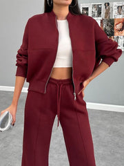 Burgundy bomber jacket and wide-leg tracksuit with drawstring waist.