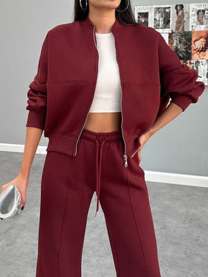 Burgundy bomber jacket and wide-leg tracksuit with drawstring waist.