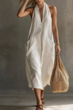White halter midi dress with V-neck and large front pockets.