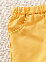 Yellow baby shorts with elastic waist and pocket detail
