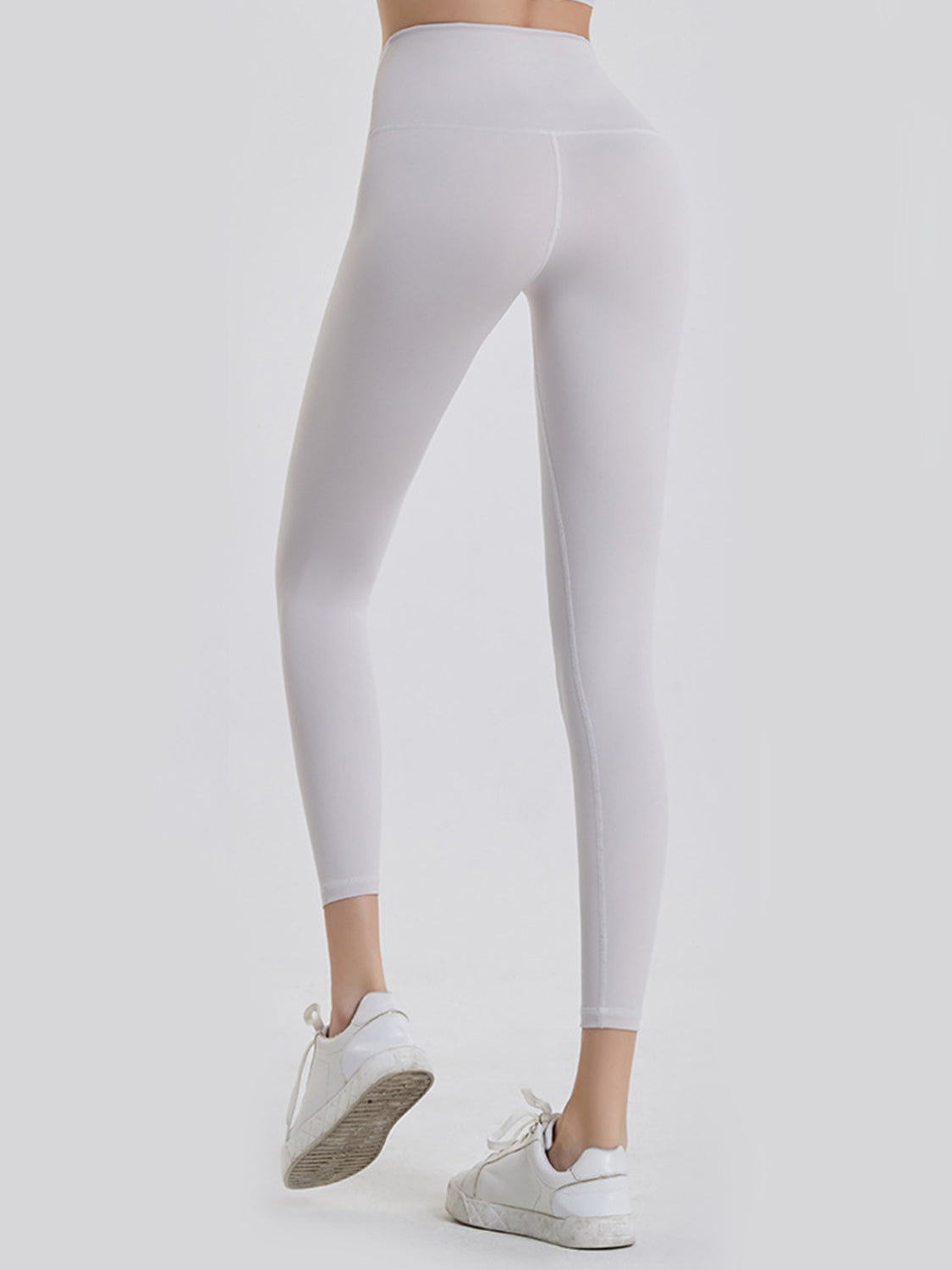 White 7/8 length leggings with a wide waistband and seamless stitching detail.
