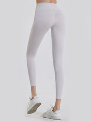 White 7/8 length leggings with a wide waistband and seamless stitching detail.