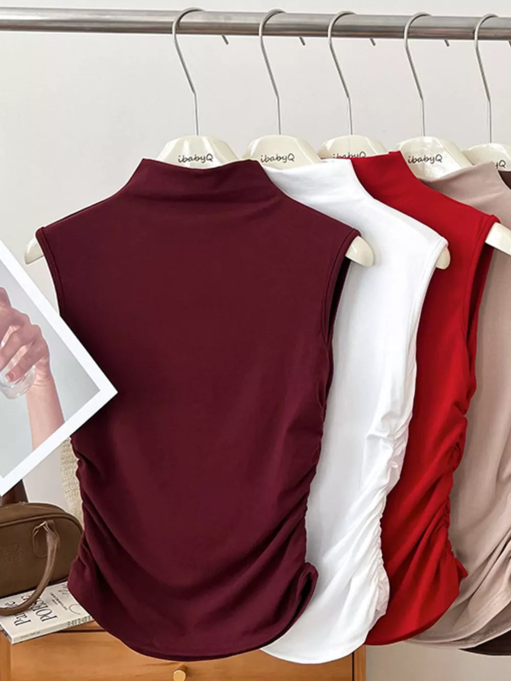 Textured ruching mock neck tank top in wine red with draped side detail.