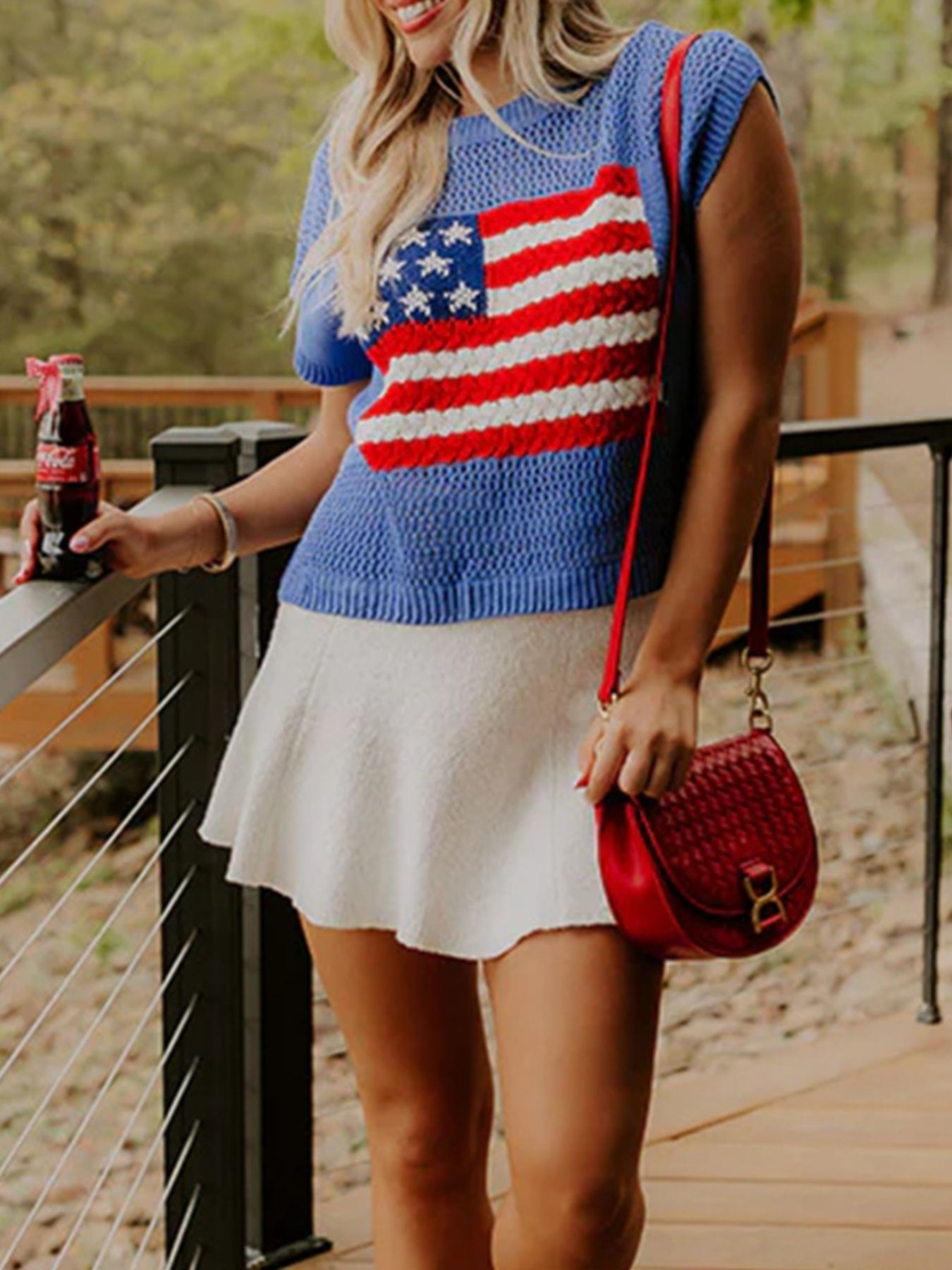 Blue acrylic knit top with American flag graphic, crew neck, and short sleeves.