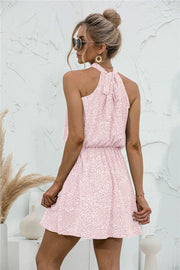 Blush pink floral halter neck mini dress with a tie back and elastic waist