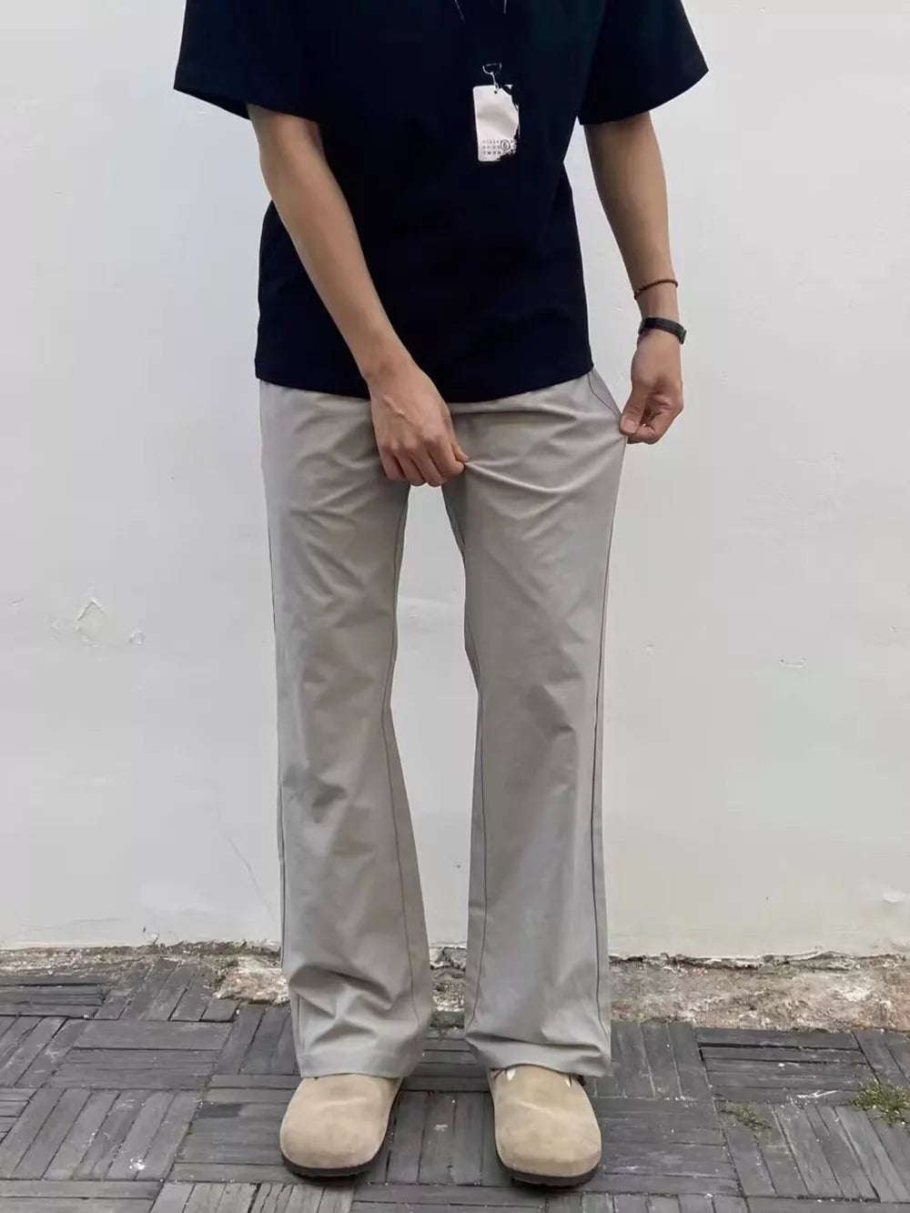 Men's light gray sweatpants with a relaxed fit and subtle seam detail.