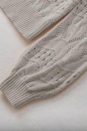 Gray openwork collar knit sweater with cable knit details and ribbed cuffs.