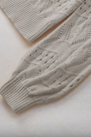 Gray openwork collar knit sweater with cable knit details and ribbed cuffs.