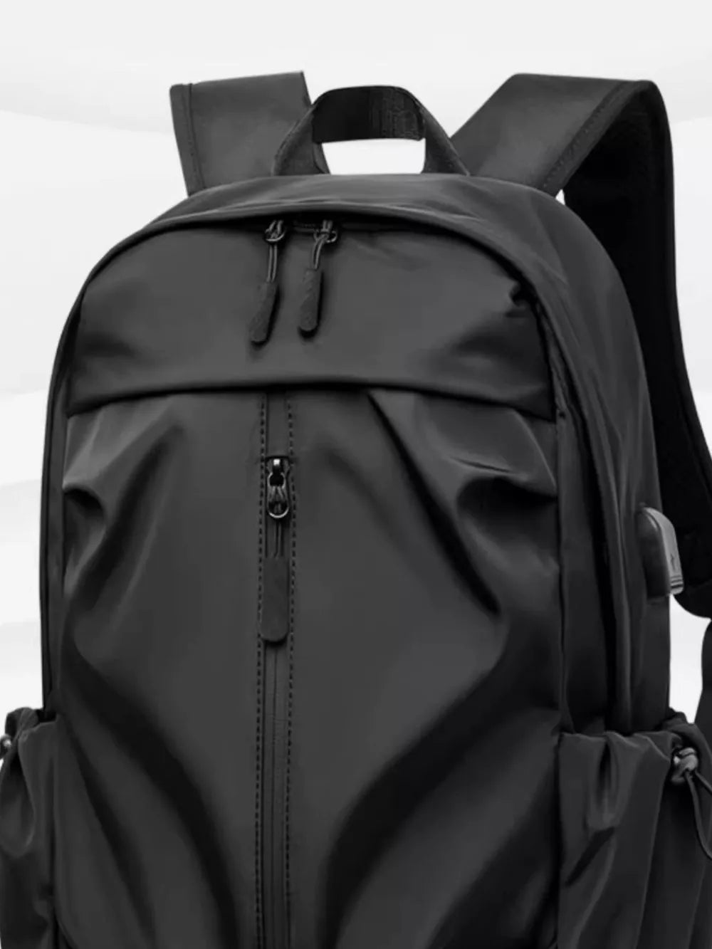 Black nylon drawstring backpack with zippered front pocket and side cinches.